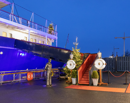 Twilight on Britannia's Quayside with a Christmas tree at the Royal Brow and on the Verandah Deck. 