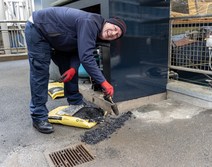 A man from the Facilities team tarmacs an area around the new filtration unit at the Royal Barge pond on the Quayside. 