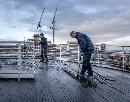 Two men removing the old decking on Fingal. 