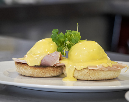 A plate of breakfast containing Eggs Benedict. 