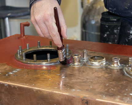 A more detailed view of the primer application to the fuel tank. 