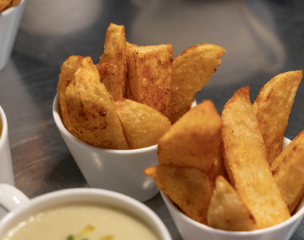 Small dishes of potato wedges. 