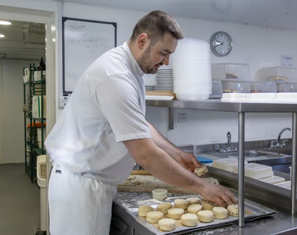 A Chef preparing scones in the Galley. 