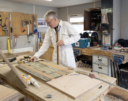 A Yottie working on deck repairs in the Maintenance team workshop. 