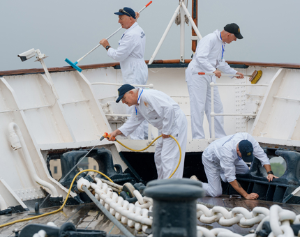 Four Yotties working on the Fo'c's'le Deck. 