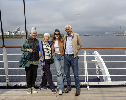 A family take a photo on deck