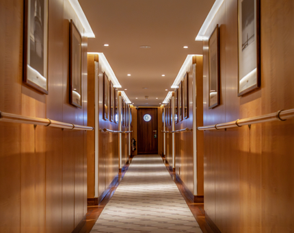 A corridor with black and white photographs lining the walls