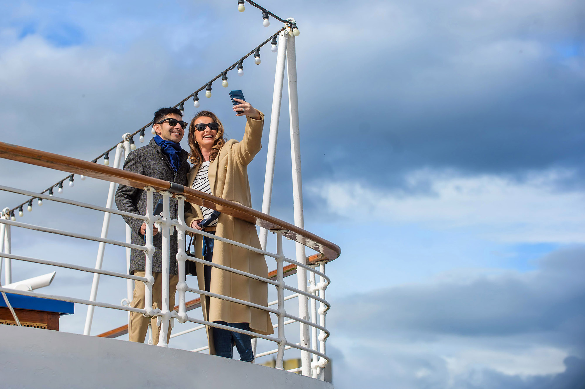 A couple on The Royal Yacht Britannia in Edinburgh taking a selfie.