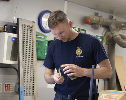 Man filling the brass ends for handrails.