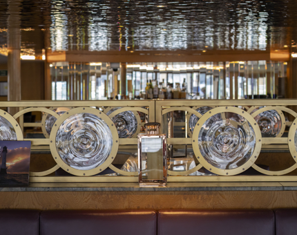 Round glass detailing and a shimmering ceiling in a restaurant. 