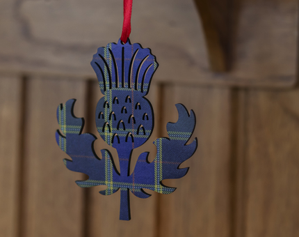 A thistle shaped hanging decoration with a tartan pattern. 