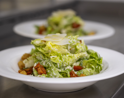 Two plates of Caesar salad. 