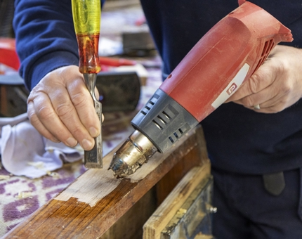 A closer look at the removal of varnish from the step of the Officers' Fast Motor Launch.