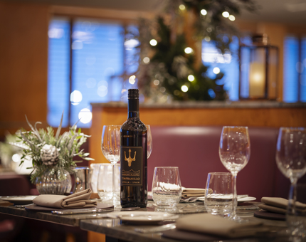 A table set with a bottle of wine and wine glasses. 