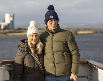 A man and a woman posing for a photo on Britannia's Bridge.