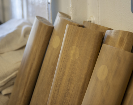 A pile of handrails ready to be varnished. 