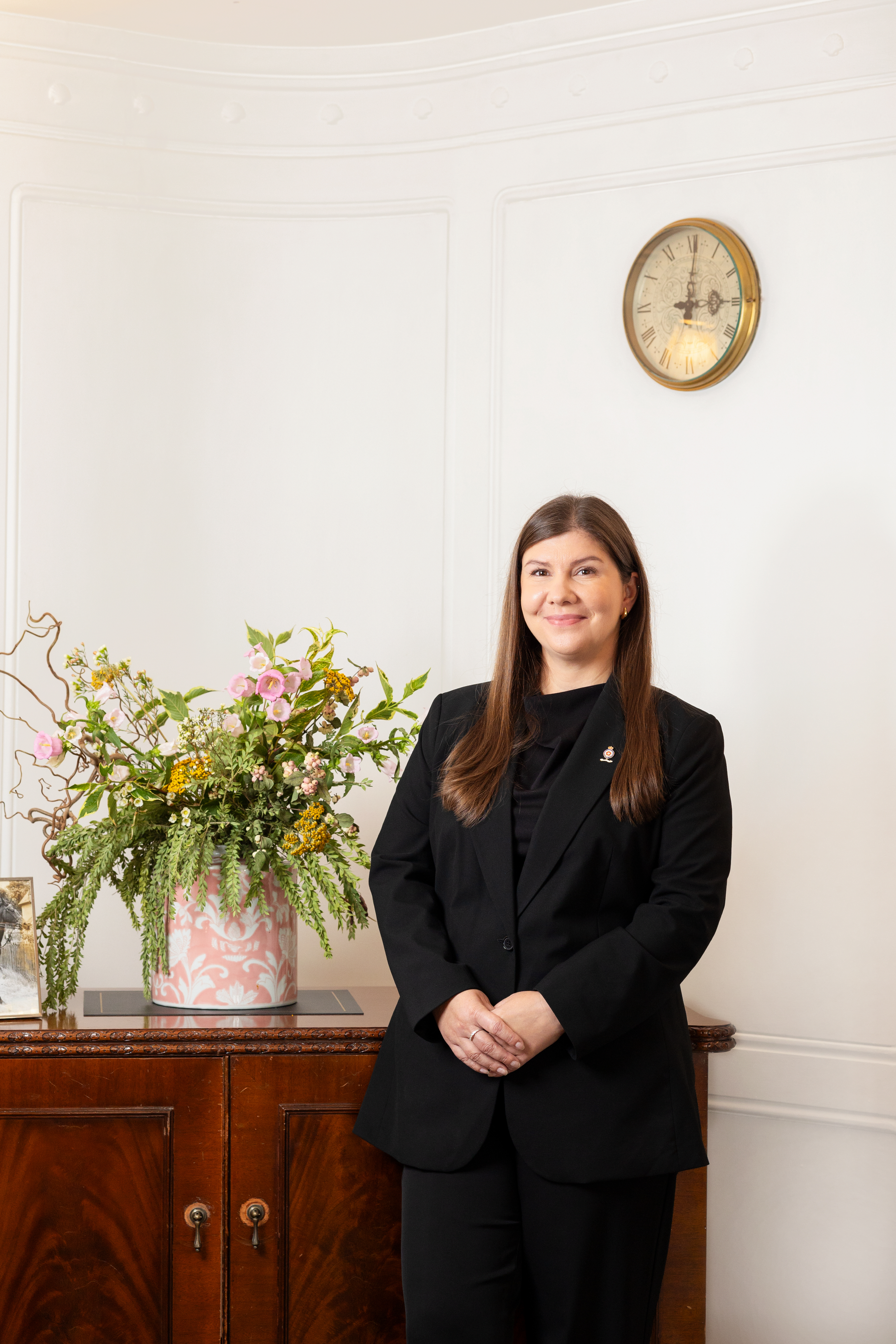 Woman standing in a drawing room for a portrait 
