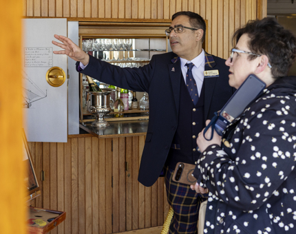 A Visitor Assistant is talking to a visitor in the Sun Lounge. 