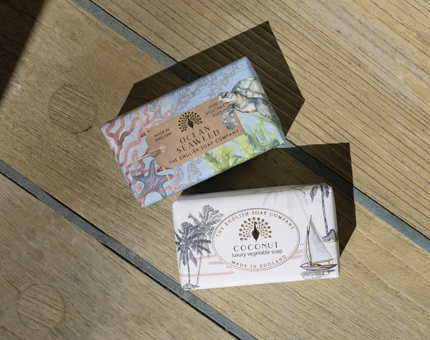 Two bars of soap made by the English Soap Company are on the deck.