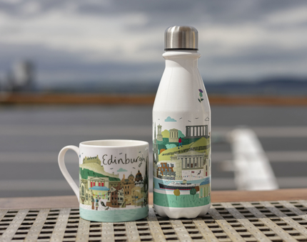 A mug and a water  bottle with an illustrated image of Edinburgh on them.