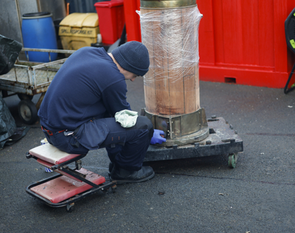 Facilities Officer, Tuckey, polishing a binnacle to be displayed aboard Britannia in Leith. 