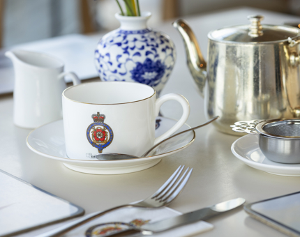 A Britannia Crested Cup and Saucer sit on a table in the Tearoom. 
