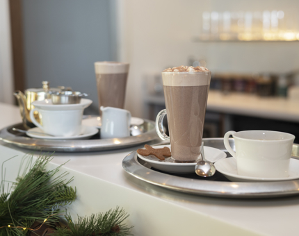 Two trays with hot chocolates and teas are on the bar of the Tearoom. 