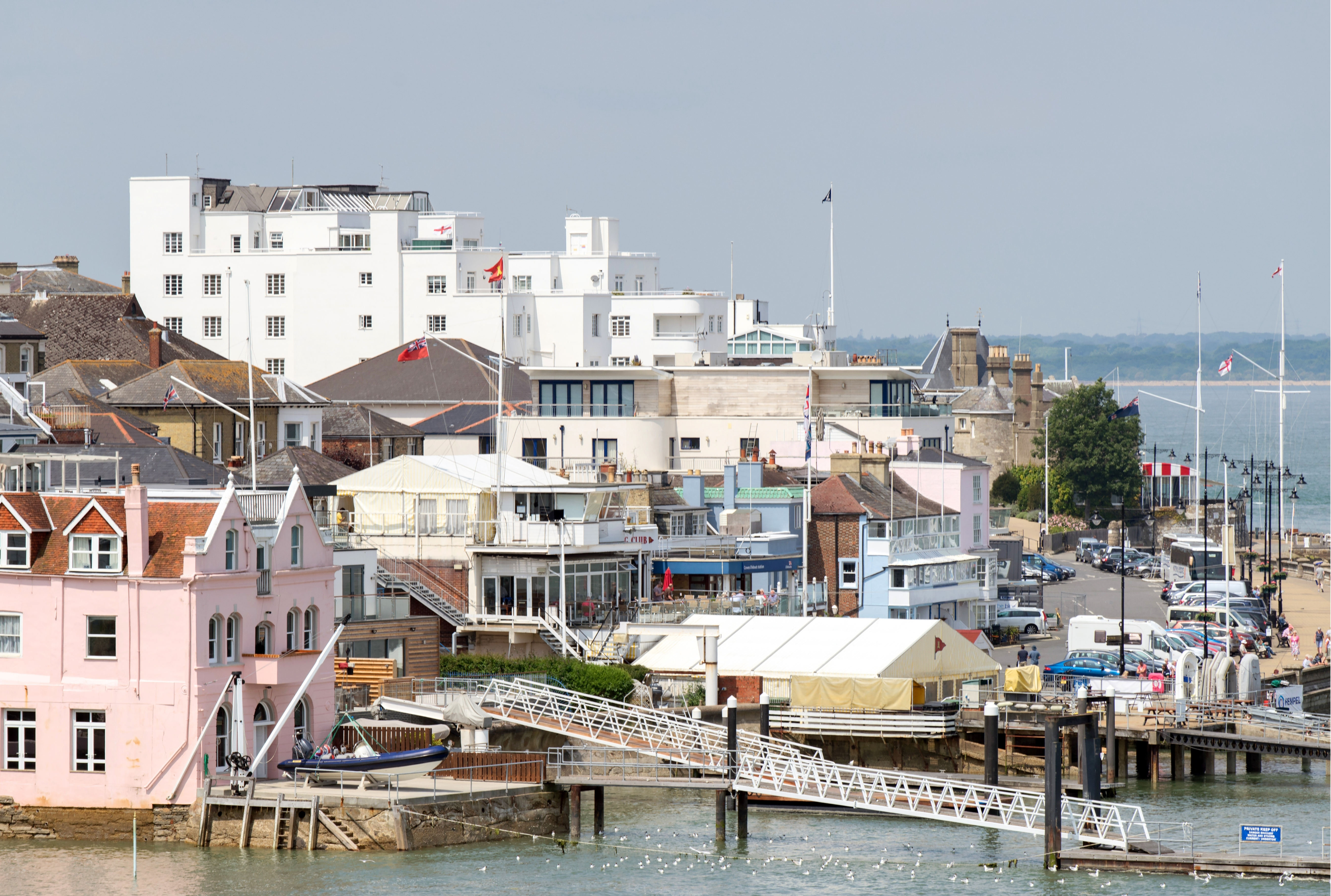 A pink building on the left is Commodores House with the Parade street on the right, along the waterfront