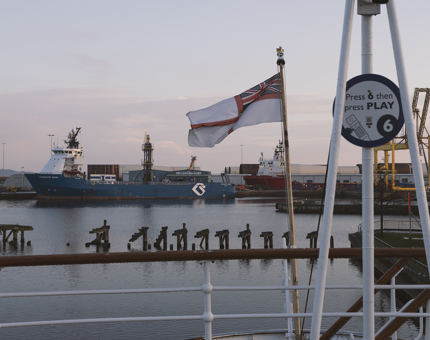 A view of the Port of Leith from Britannia's Verandah Deck. There is a ship in the background. 