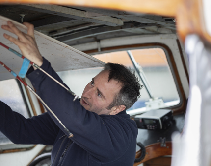 Chris removing roof panel to replace wood in ceiling supports on the Fast Motor Launch.