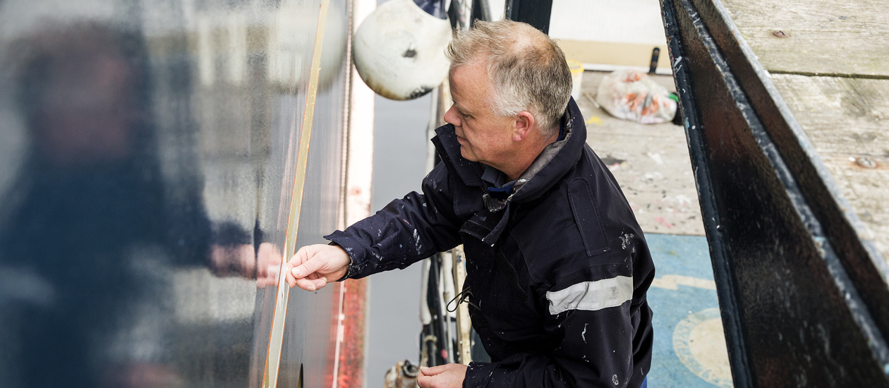 Nigel applying the gold leaf to the ship.