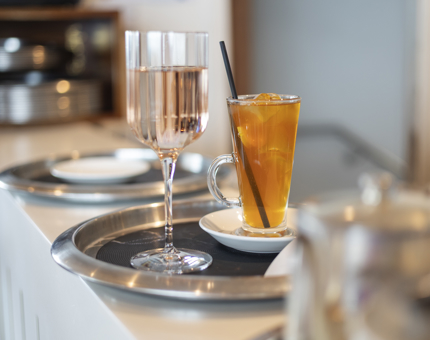 In the Royal Deck Tearoom, there is a tray on the bar with glasses of iced tea and pink fizz. 
