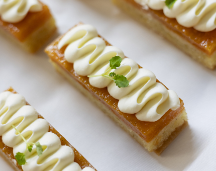 A close up of rectangular cakes with white icing