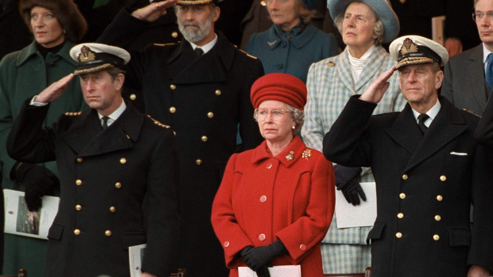 Queen Elizabeth II and Prince Philip and Prince Charles standing side by side