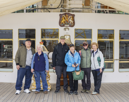 Six Visitors Posing for a photo  at Britannia's Bell in Leith. 