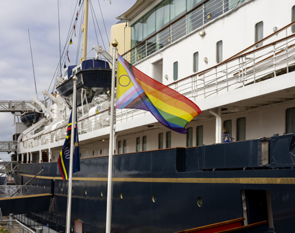 A Progress Pride Flag flying on the quayside. 