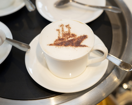 A cappuccino with a chocolate ship stencil, the Royal Deck Tearoom. 