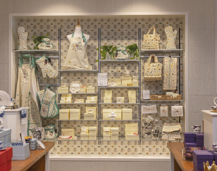 The Embroidery range of the Shop's products. There are many items such a aprons, oven gloves, teapots and bags. 