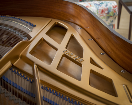 A closeup of the inside of a grand piano in Britannia's Drawing Room. 