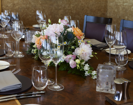 The table in Fingal's Bridge is set for a wedding with a floral arrangement in the centre. 