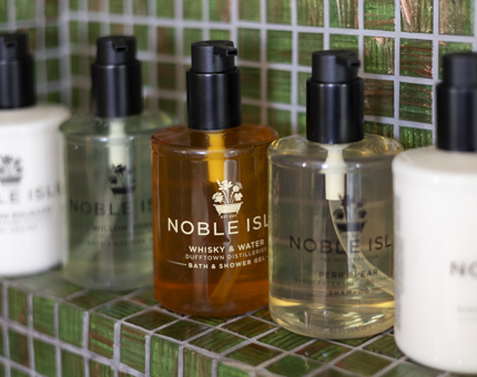 A set of Noble Isle branded bath and body products in the bathroom of one of Fingal's cabins. 