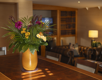 On the table in the Skerryvore Suite is a vase with flowers in it. 