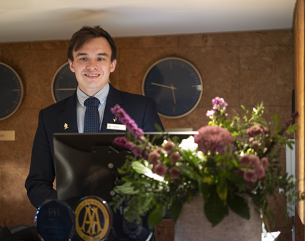 Artiom, Guest Services Assistant, welcomes guests aborad Fingal Hotel