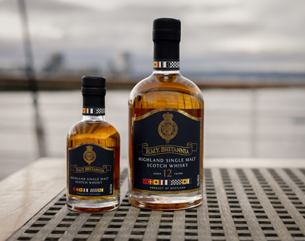 A large and a miniature bottle of whisky. It is aged 12 years and is highland single malt scotch whisky. 