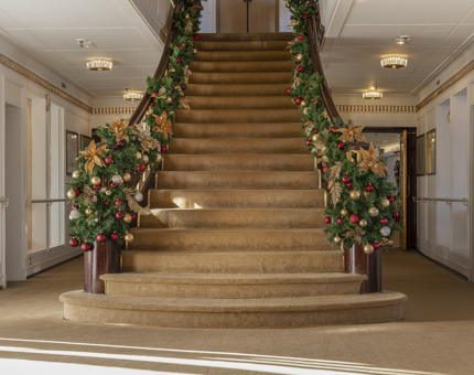 The Grand Staircase aboard The Royal Yacht Britannia decorated with Christmas garlands.