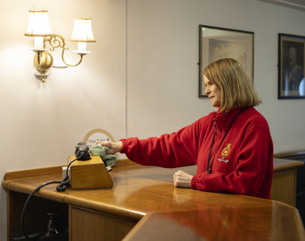 A Housekeeper is cleaning the bar area in the Wardroom Anteroom aboard Britannia in Leith. 