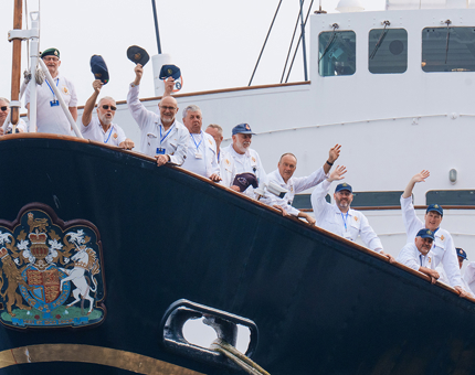 Royal Yachtsmen at the bow of Britannia waving. 