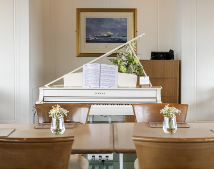 A white grand piano in the Tearoom in Leith. 