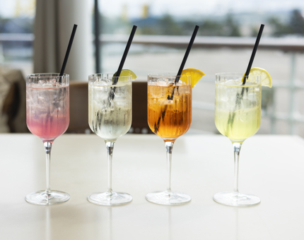 Four glasses form the Summer Sprits range in the Tearoom. The are all different colours with black straws. 