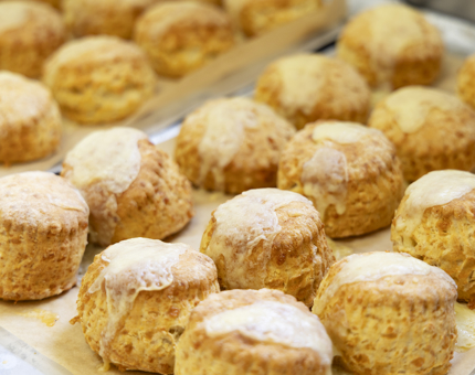 A close up of a tray of cheese scones in Britannia's Galley. 